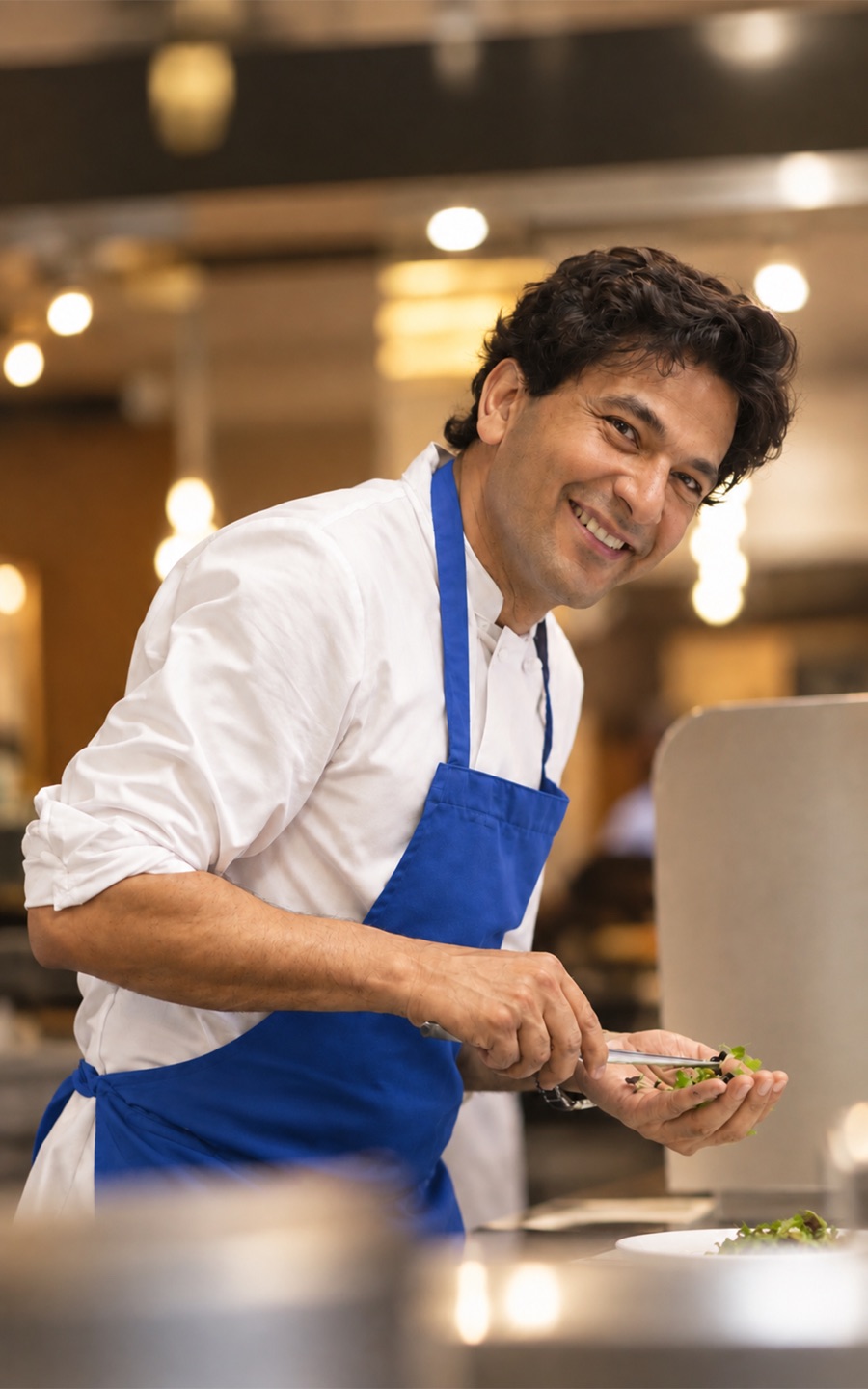 Chef plating a dish in a restaurant kitchen