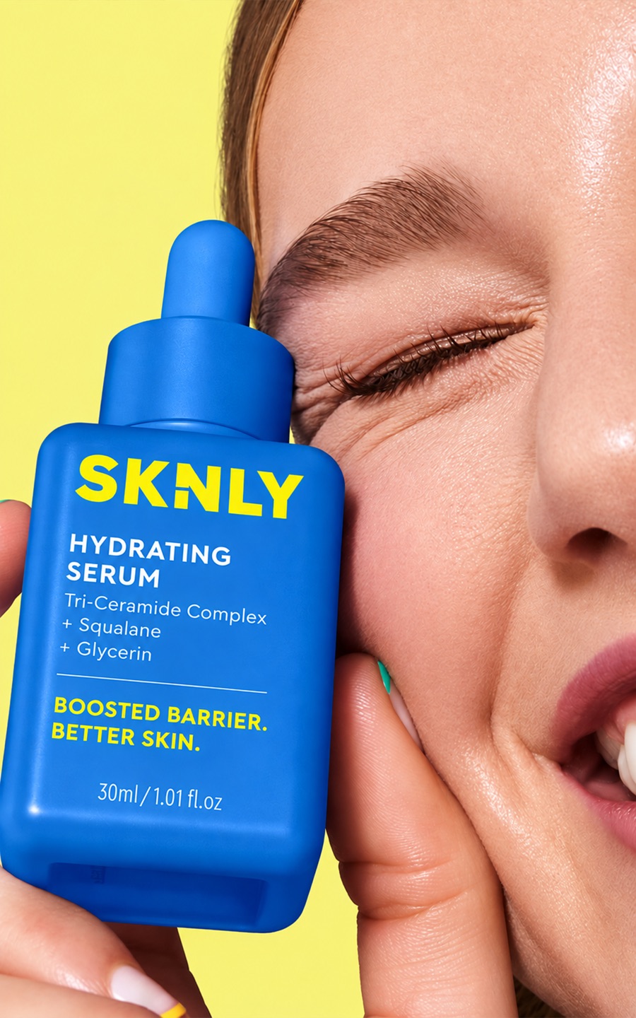 Close-up beauty shot of a model holding a skincare serum bottle